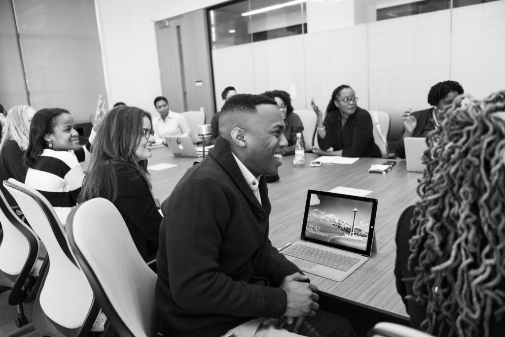 Business professionals engaged in a collaborative meeting in a modern office setting.